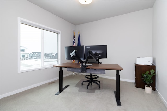 office space featuring light carpet, visible vents, and baseboards