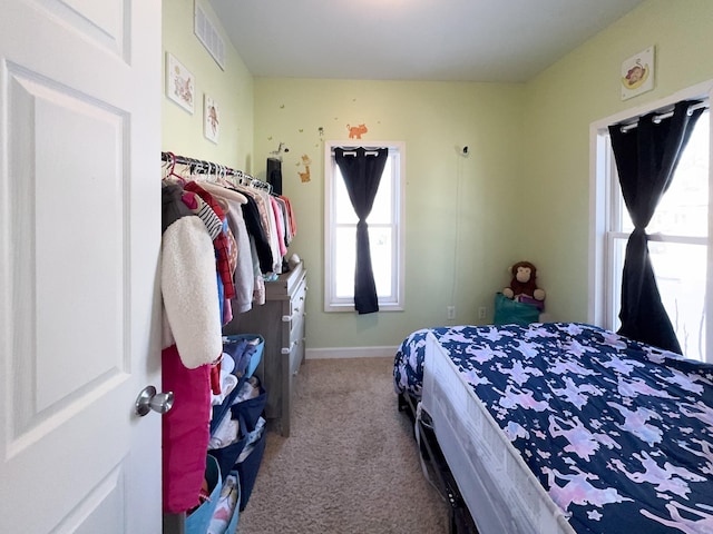 bedroom with carpet, visible vents, and baseboards