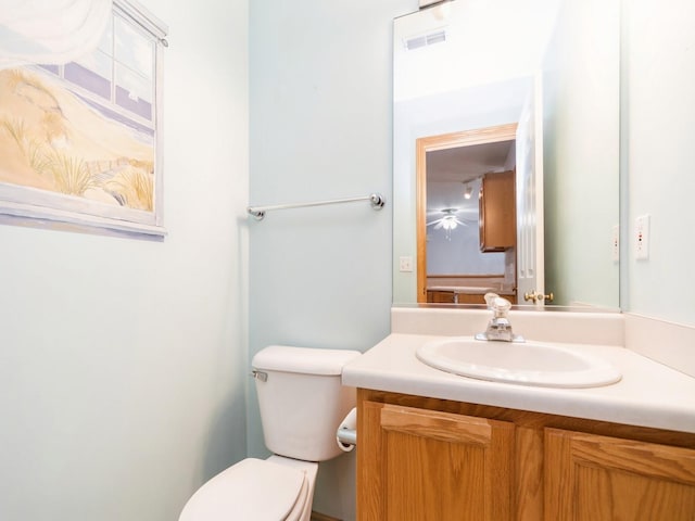 bathroom with visible vents, vanity, and toilet