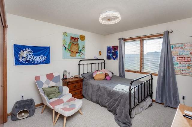 bedroom featuring a textured ceiling and carpet