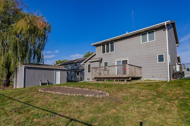 rear view of property with a deck, a storage shed, an outdoor structure, fence, and a yard