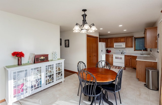 dining space featuring baseboards, a notable chandelier, and recessed lighting