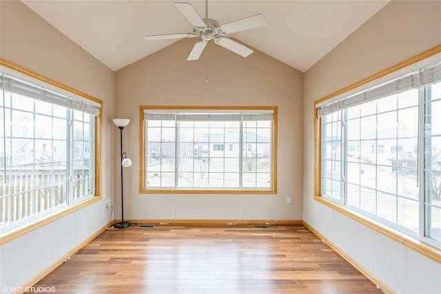 interior space featuring lofted ceiling, plenty of natural light, and light wood-style floors