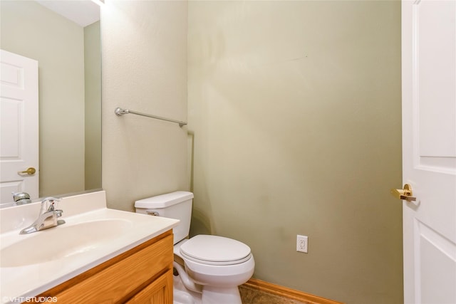 half bathroom with vanity and toilet