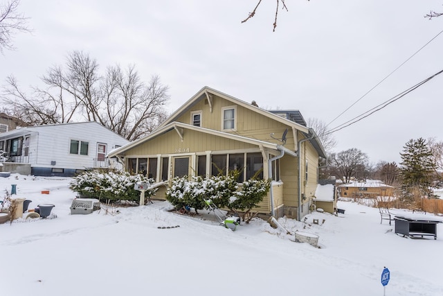 view of front of property featuring a sunroom