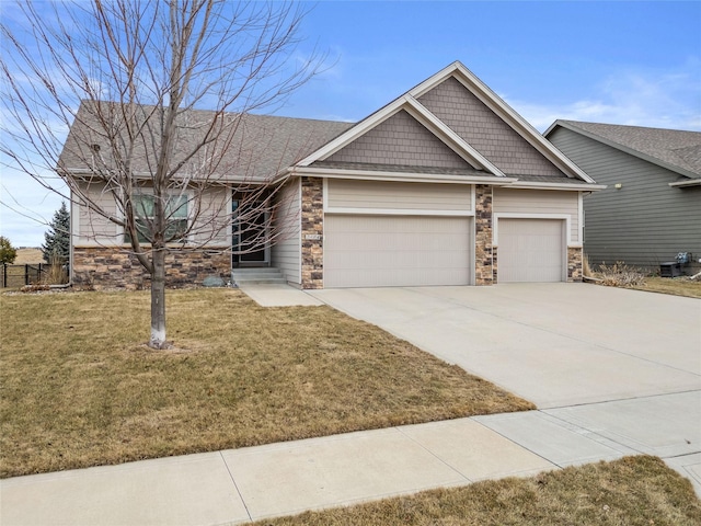 view of front of home featuring stone siding, a front lawn, and concrete driveway