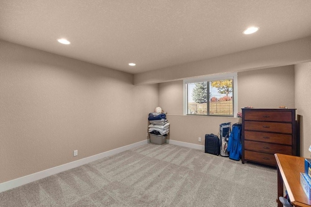 basement with recessed lighting, baseboards, and light colored carpet