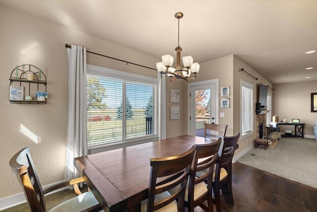 dining area with an inviting chandelier, baseboards, and dark wood finished floors