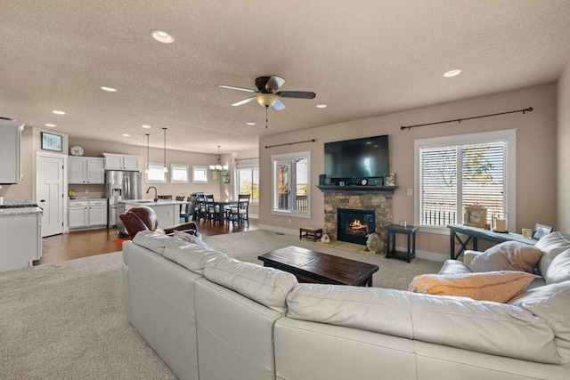 living area featuring plenty of natural light, a textured ceiling, and recessed lighting