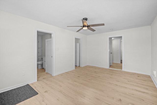 unfurnished bedroom featuring ensuite bathroom, ceiling fan, light wood finished floors, and baseboards