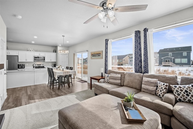 living area featuring recessed lighting, ceiling fan, and wood finished floors