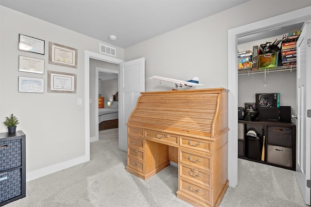 office space featuring light carpet, baseboards, and visible vents