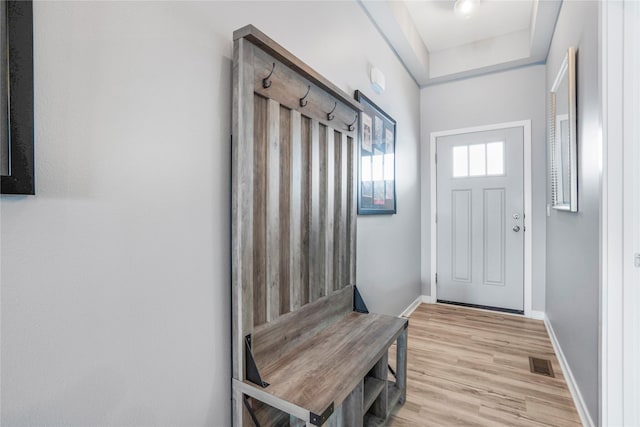 mudroom featuring light wood-type flooring, visible vents, and baseboards