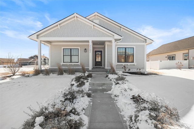 view of front of house with fence and a porch