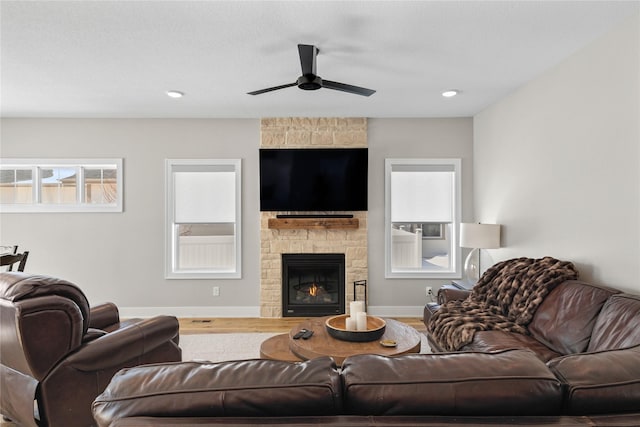 living room featuring baseboards, ceiling fan, wood finished floors, a fireplace, and recessed lighting