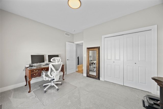 office space with light carpet, visible vents, and baseboards