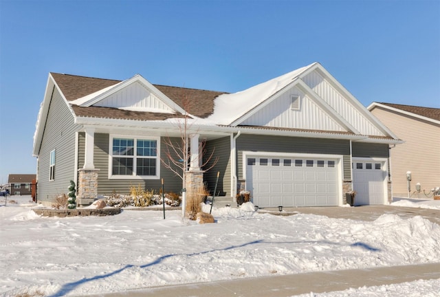 craftsman inspired home featuring a garage, a shingled roof, and board and batten siding