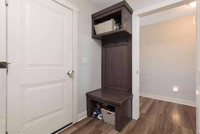 mudroom with dark wood-style flooring and baseboards