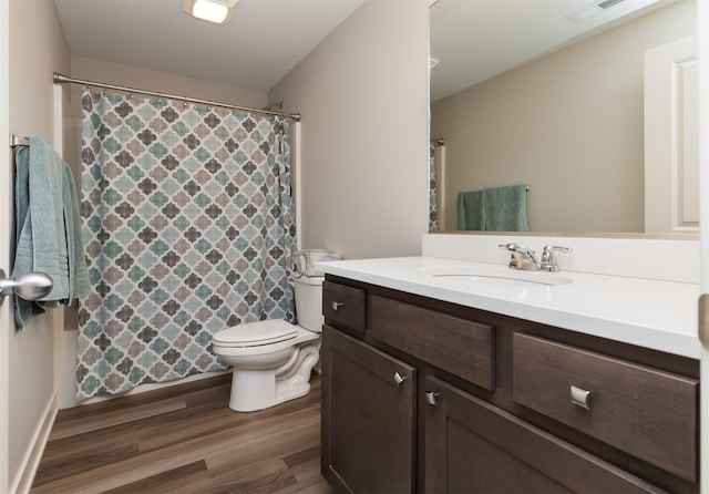 full bathroom featuring visible vents, vanity, toilet, and wood finished floors