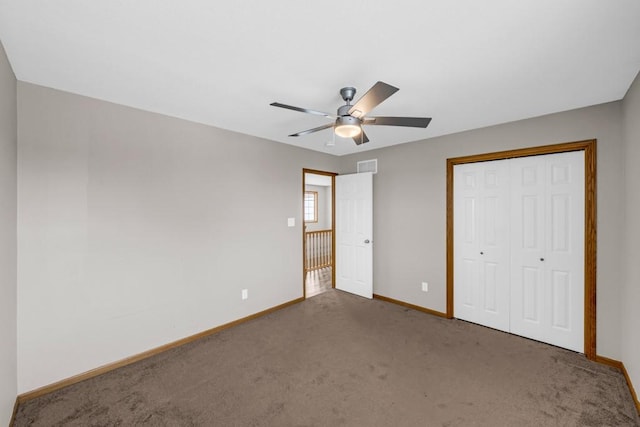 unfurnished bedroom with ceiling fan, visible vents, baseboards, a closet, and dark carpet