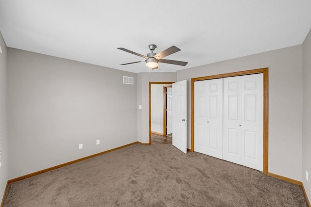 unfurnished bedroom with carpet, a closet, visible vents, and baseboards