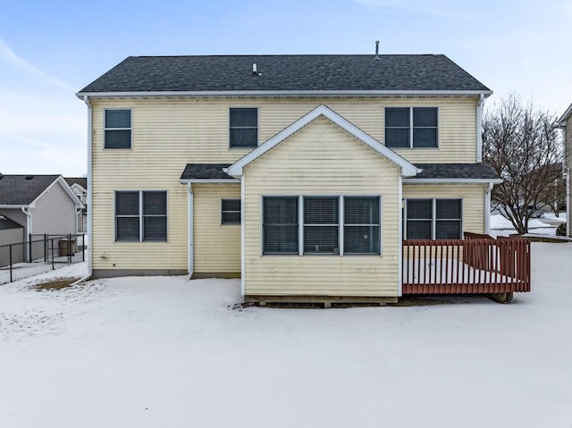 snow covered house with roof with shingles