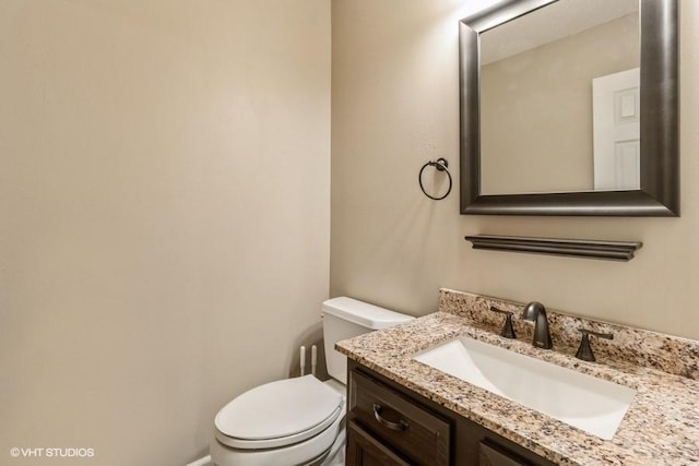 bathroom with toilet and vanity