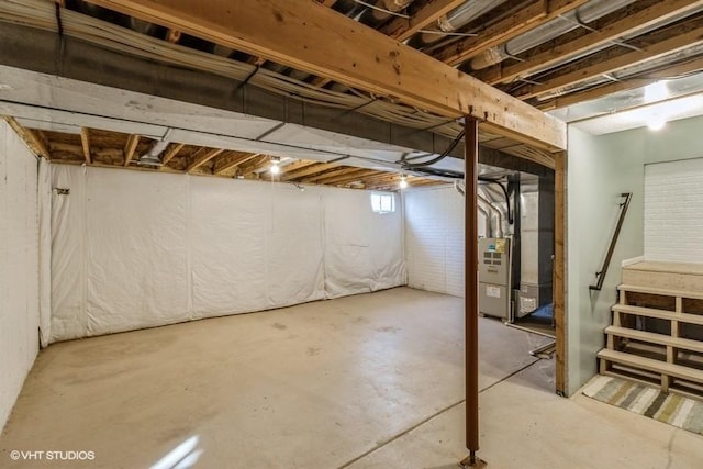 unfinished below grade area with stairs and heating unit