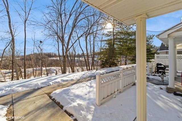 yard layered in snow featuring fence