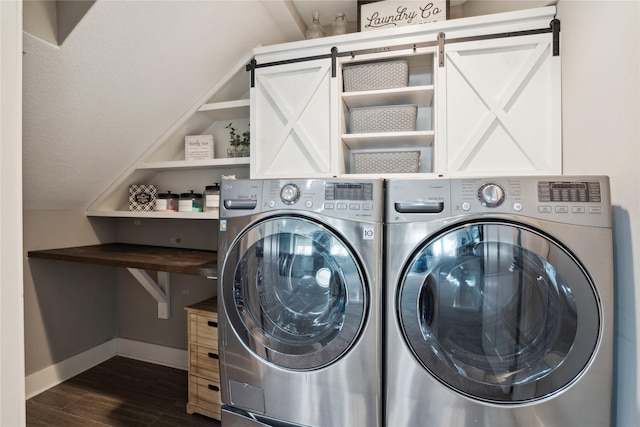 washroom with dark wood-style floors, washer and dryer, laundry area, and baseboards