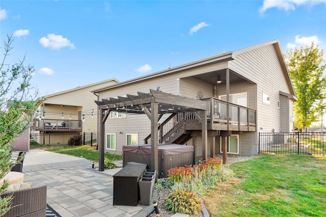 back of property with a patio, a hot tub, fence, a pergola, and stairs