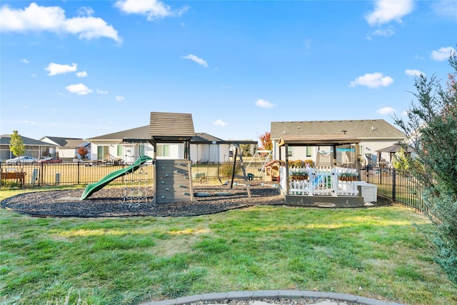 communal playground with fence and a yard