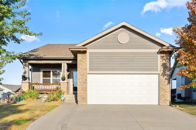 view of front of property with a porch, a garage, concrete driveway, roof with shingles, and a front yard