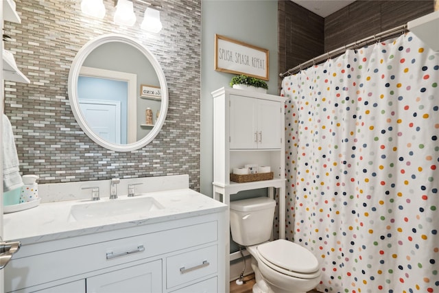 full bathroom featuring curtained shower, vanity, and toilet