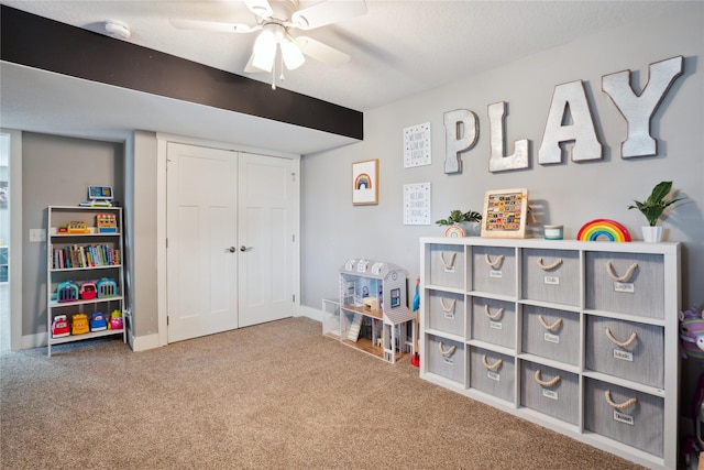 game room featuring carpet flooring, ceiling fan, and baseboards