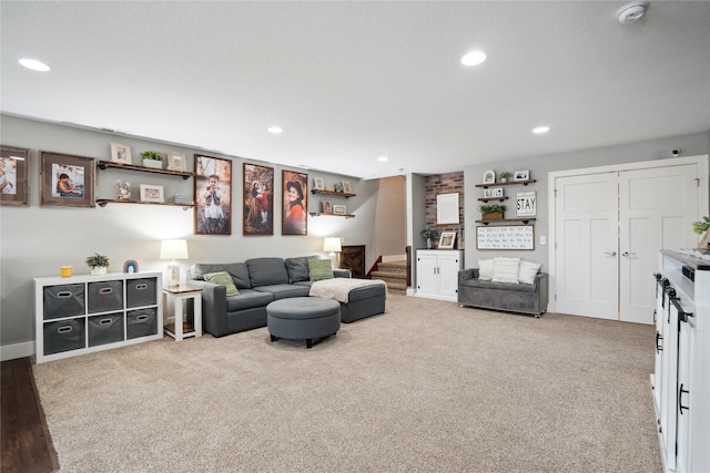 living room with light carpet, stairs, and recessed lighting