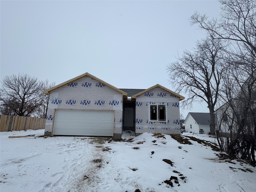 property under construction with fence and an attached garage