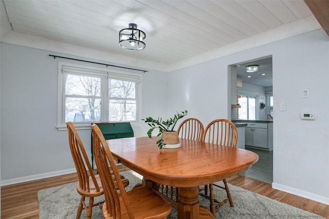 dining space featuring baseboards and wood finished floors