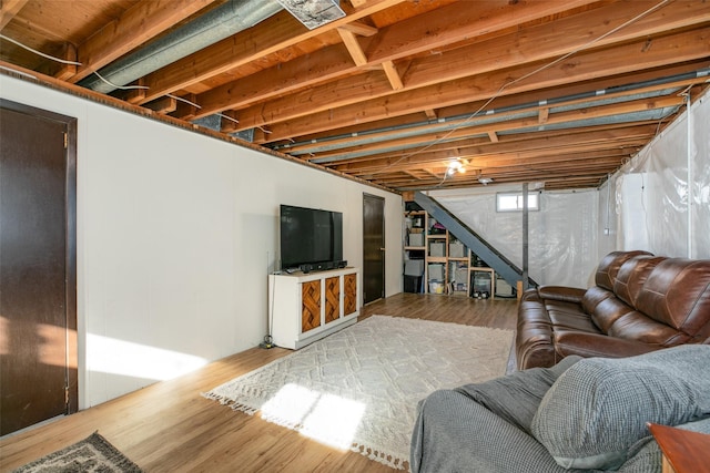 living area featuring stairs and wood finished floors