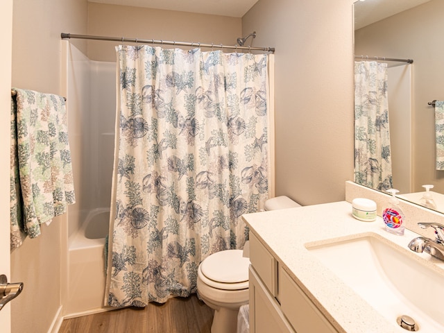 bathroom featuring shower / bath combo, wood finished floors, toilet, and vanity