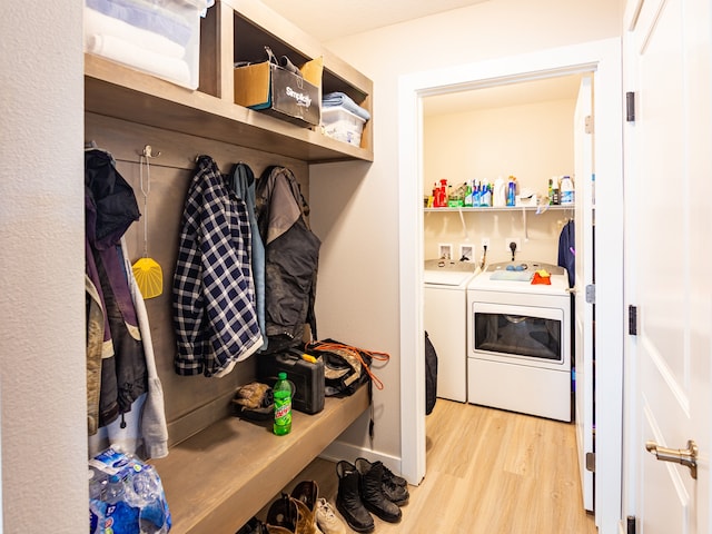 mudroom featuring light wood-style flooring and washer and dryer