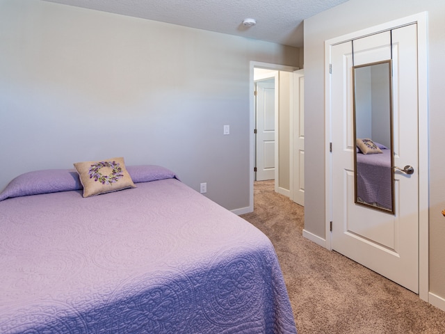 bedroom featuring baseboards and light colored carpet