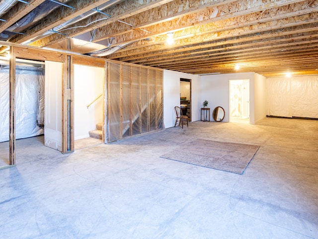 unfinished below grade area featuring stairs