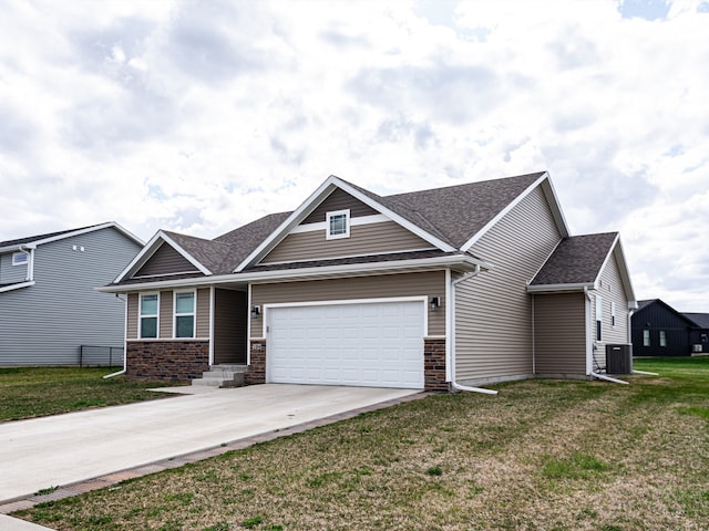 craftsman inspired home with roof with shingles, central AC, concrete driveway, a garage, and a front yard