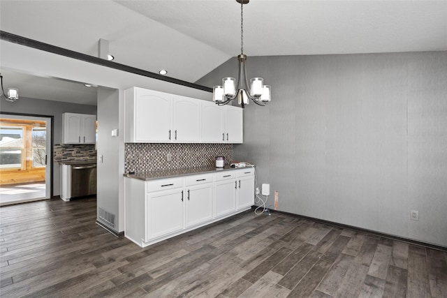 kitchen featuring dark wood-type flooring, dark countertops, pendant lighting, and white cabinets