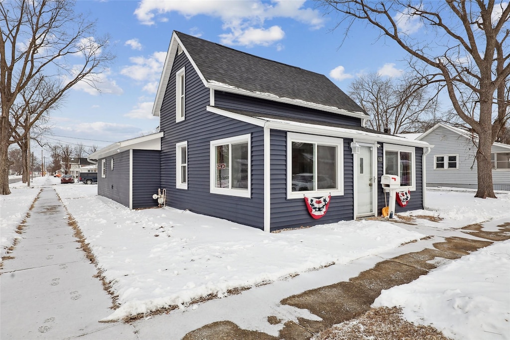 view of front of property featuring roof with shingles