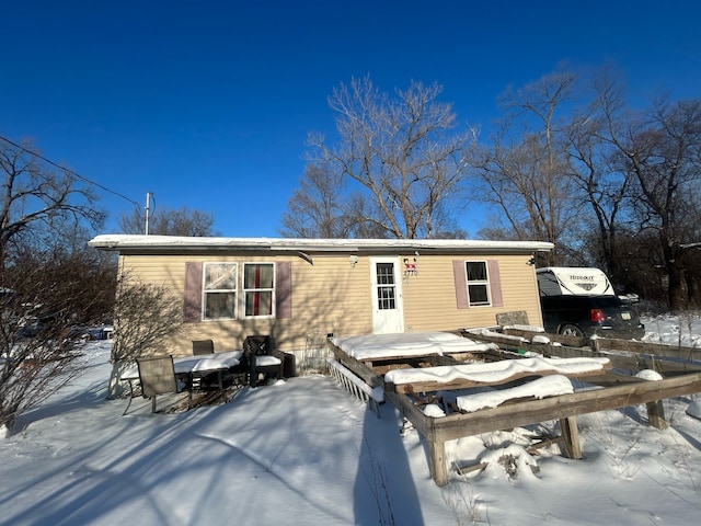 view of snow covered back of property