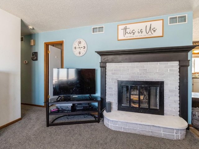 3473 Juniper Ave, Casey, IA 50048 - carpeted living area featuring baseboards, a brick fireplace, a textured ceiling, and visible vents