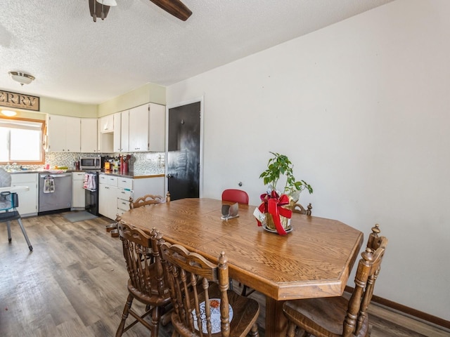 3473 Juniper Ave, Casey, IA 50048 - dining space with light wood-type flooring, a ceiling fan, and a textured ceiling