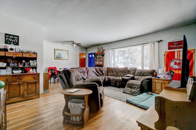 living room with ceiling fan and light wood-style flooring